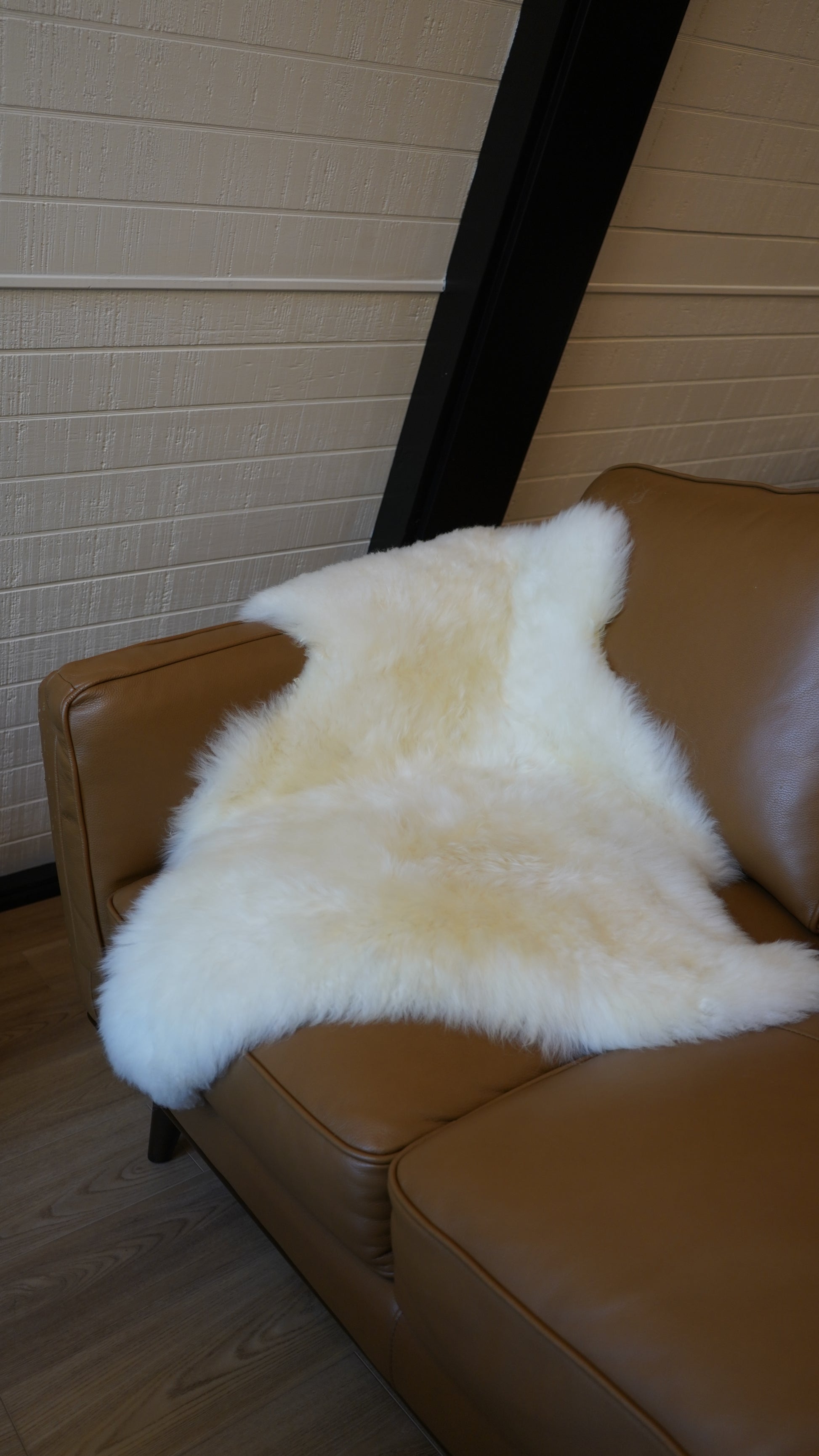 Natural sheepskin rug used as a soft accent on indoor seating
