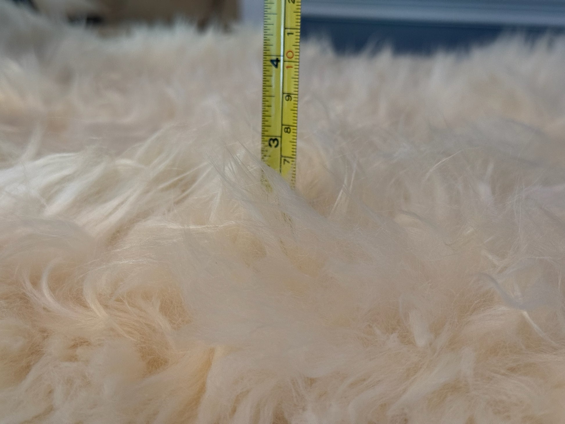 Detailed close-up of soft wool fibers on a natural sheepskin rug

