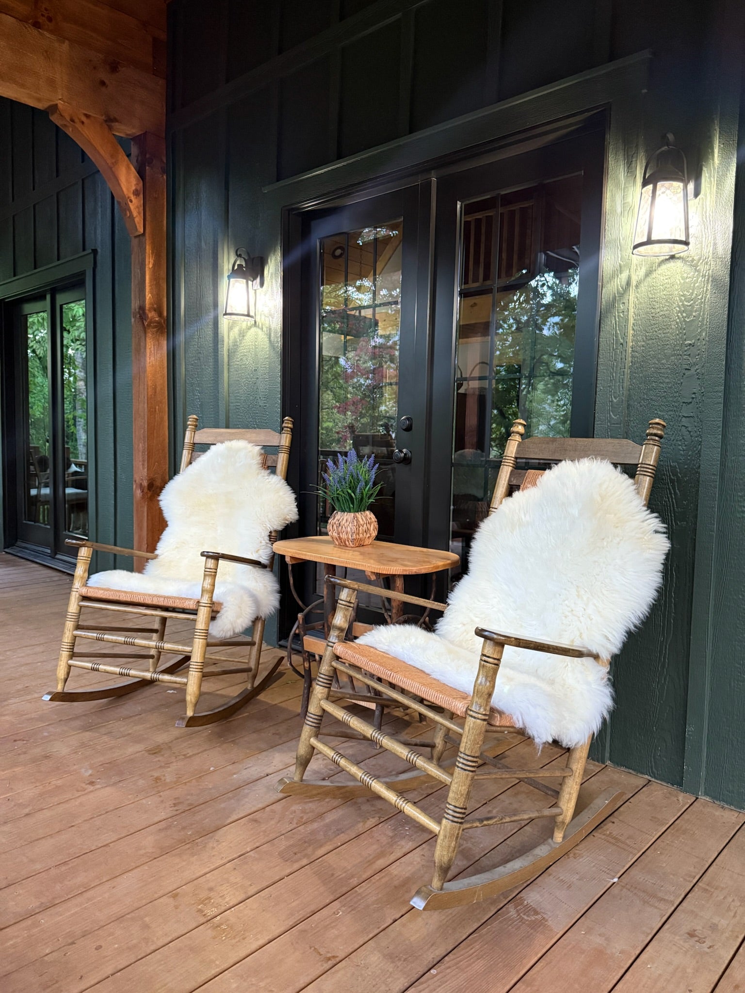 Natural sheepskin rug used as cozy seating decor in a cafe-style interior
