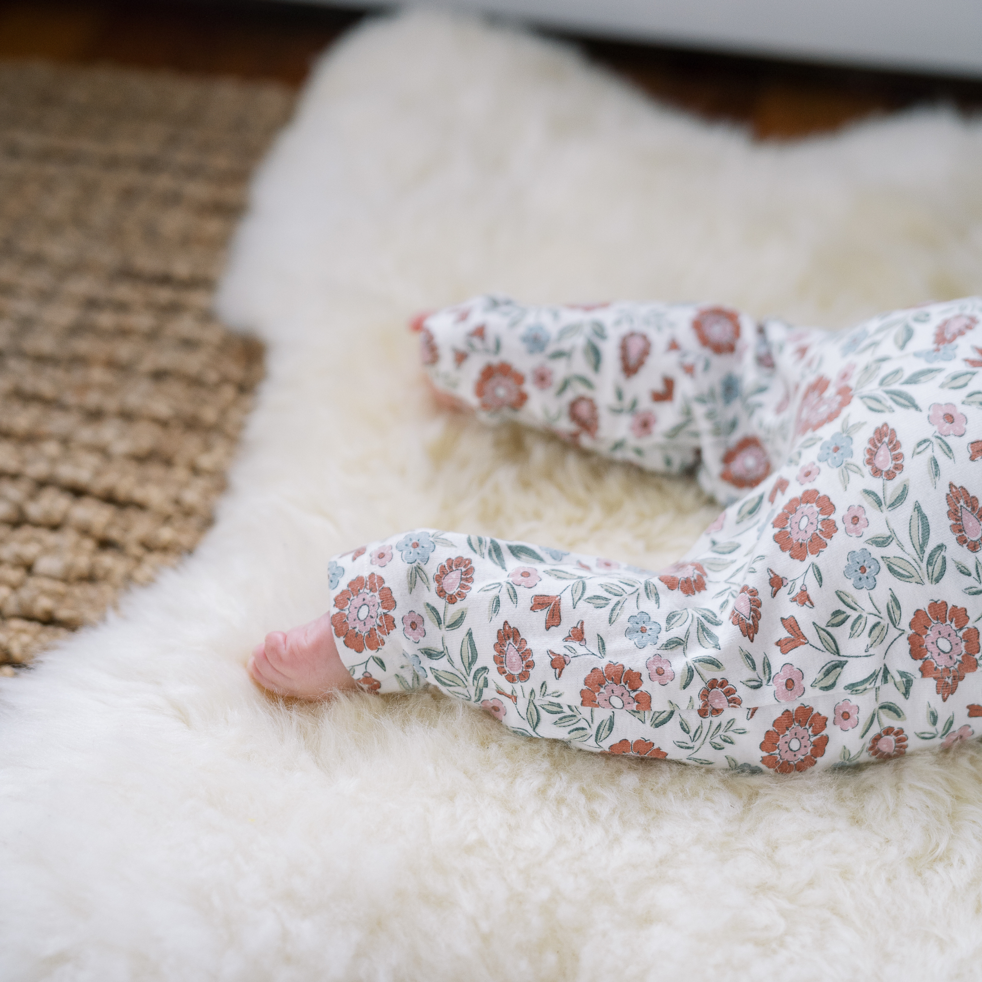 Natural sheepskin rug used as a soft and safe play surface for babies
