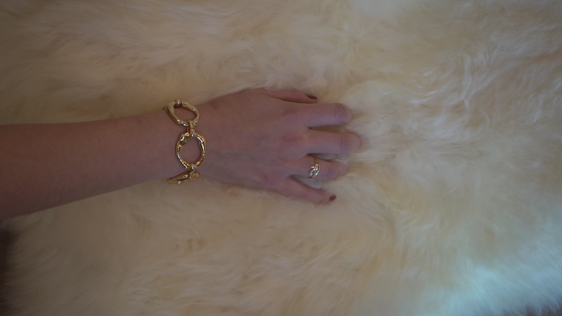 Close-up showing the soft wool texture of a natural sheepskin rug against skin
